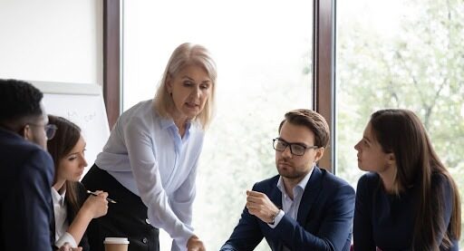 a customer experience manager meeting her team.